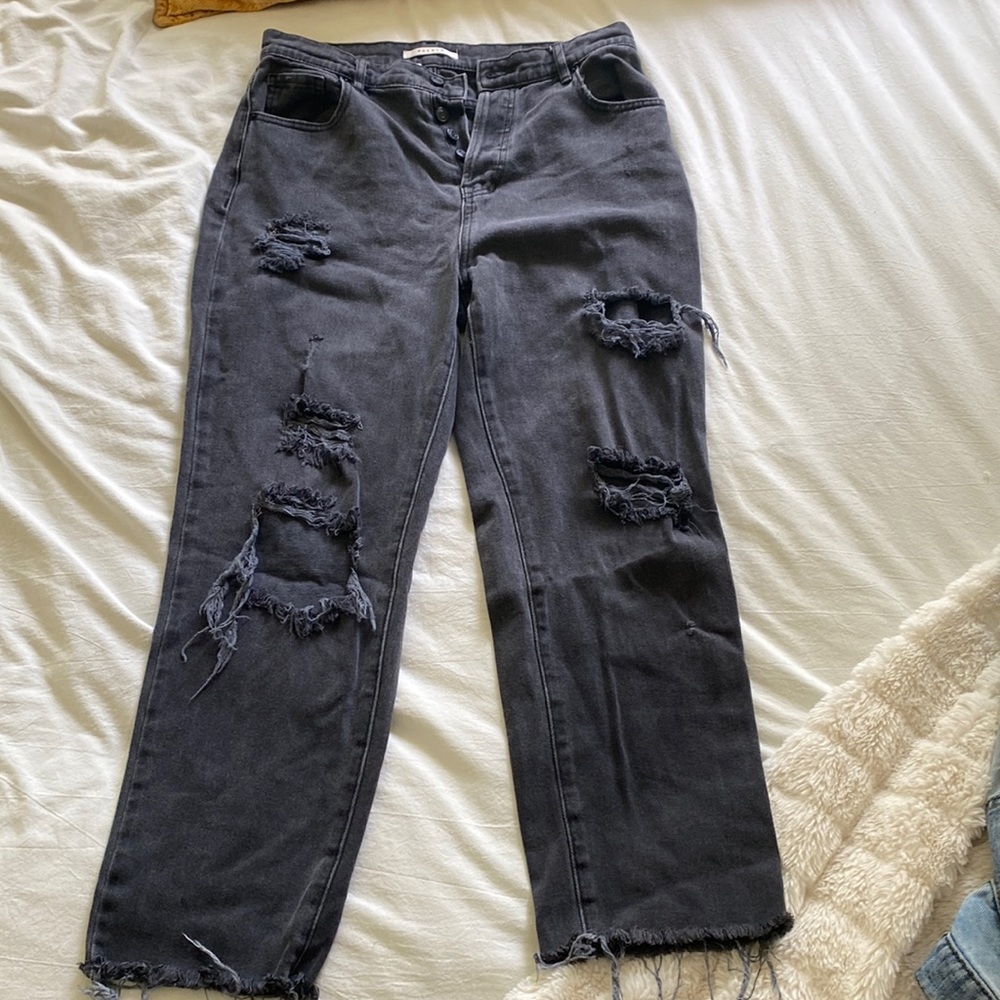 Black, ripped, high waisted mom jeans with distressed bottoms